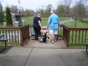 Grandparents and grandchild golfing heron creek